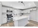 Modern kitchen showcasing white cabinetry, stainless steel appliances, a center island and sleek countertops at 139 Ivy St, Henderson, NV 89015