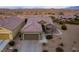 Single-story home with a two-car garage and desert landscaping at 1460 Tannery Hts, Mesquite, NV 89034