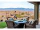 Covered patio with fire pit and mountain views at 1460 Tannery Hts, Mesquite, NV 89034