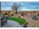 Landscaped backyard with artificial turf and mountain views at 1460 Tannery Hts, Mesquite, NV 89034