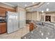 White refrigerator and wood cabinets in kitchen at 1460 Tannery Hts, Mesquite, NV 89034