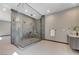 Modern bathroom features a large glass shower with dual shower heads and gray tile at 1469 Dragon Stone Pl, Henderson, NV 89012