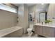 Modern bathroom featuring a sleek vanity, soaking tub, and neutral tile at 1469 Dragon Stone Pl, Henderson, NV 89012