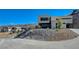 Modern two-story home with desert landscaping and a concrete driveway at 1469 Dragon Stone Pl, Henderson, NV 89012