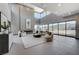 Bright living room with floor-to-ceiling windows, fireplace, and comfortable seating arrangement at 1469 Dragon Stone Pl, Henderson, NV 89012