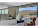 Modern living room with outdoor balcony showcasing mountain views at 1469 Dragon Stone Pl, Henderson, NV 89012