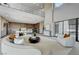 Expansive living room featuring a curved sofa, modern coffee table, and a balcony view at 1469 Dragon Stone Pl, Henderson, NV 89012