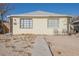 Quaint yellow house with small yard and seating at 203 N 13Th St, Las Vegas, NV 89101