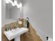 Elegant powder room with pedestal sink and unique wall detail at 204 Appian Way, Henderson, NV 89002