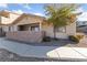 Inviting exterior of a single-story home with a covered patio and landscaping at 2050 N Los Feliz St # 133, Las Vegas, NV 89156