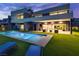 A backyard pool with lounge chairs and a covered patio with spiral staircase and view of the home's rear exterior at 21 Canyon Bay Dr, Henderson, NV 89011