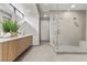 Bright bathroom with a double sink floating vanity, contemporary mirrors, and a large glass-enclosed walk-in shower at 21 Canyon Bay Dr, Henderson, NV 89011