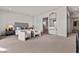 Main bedroom with plush carpet, gray upholstered bed and access to bathroom at 21 Canyon Bay Dr, Henderson, NV 89011