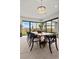 Bright dining room with wood table and modern chandelier, overlooking backyard at 21 Canyon Bay Dr, Henderson, NV 89011