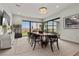 Modern dining room with contemporary lighting, expansive windows, and stylish decor at 21 Canyon Bay Dr, Henderson, NV 89011