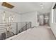 Upstairs hallway with modern chandelier and railing at 21 Canyon Bay Dr, Henderson, NV 89011