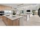 A sunlit modern kitchen features an island with bar seating, stainless steel appliances, and seamless flow to the backyard at 21 Canyon Bay Dr, Henderson, NV 89011