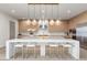 Gourmet kitchen with large island, modern lighting and stainless steel appliances at 21 Canyon Bay Dr, Henderson, NV 89011