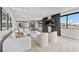 Modern living room featuring a plush white sectional, stylish chairs, and large windows with neighborhood views at 21 Canyon Bay Dr, Henderson, NV 89011