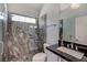 Elegant bathroom featuring a glass enclosed shower with custom tile, a sink, and a toilet at 2200 Nordica Ct, Las Vegas, NV 89117