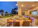 Large granite outdoor kitchen with seating and a built-in TV at 2200 Nordica Ct, Las Vegas, NV 89117