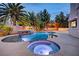 Luxury pool and spa with a fire feature and outdoor entertainment area at 2200 Nordica Ct, Las Vegas, NV 89117