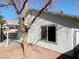 Back exterior view of house with backyard access, and a covered patio at 2420 Sweetgum St, Las Vegas, NV 89108