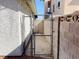 Backyard chain link gate access point between two brick walls at 2420 Sweetgum St, Las Vegas, NV 89108