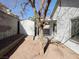 View of backyard featuring a tree, gravel landscape and a storage shed at 2420 Sweetgum St, Las Vegas, NV 89108