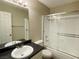 Standard bathroom with a vanity sink and shower over tub with glass doors at 2420 Sweetgum St, Las Vegas, NV 89108