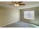 Neutral toned bedroom features a ceiling fan and window bringing in natural light at 2420 Sweetgum St, Las Vegas, NV 89108