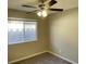 Carpeted bedroom with ceiling fan and window overlooking the backyard at 2420 Sweetgum St, Las Vegas, NV 89108