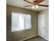 Bright bedroom featuring window, ceiling fan and fresh carpet at 2420 Sweetgum St, Las Vegas, NV 89108