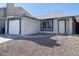 Quaint single story home featuring a garage and minimal desert landscaping in the front at 2420 Sweetgum St, Las Vegas, NV 89108