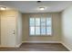 Neutral room featuring vinyl plank flooring, door and a large window with white shutters at 2420 Sweetgum St, Las Vegas, NV 89108