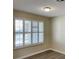 Bright living room features modern vinyl flooring and a large window with wood shutters at 2420 Sweetgum St, Las Vegas, NV 89108