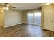 Open living room features vinyl plank flooring, ceiling fan, and door leading to outdoor space at 2420 Sweetgum St, Las Vegas, NV 89108