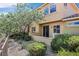 Backyard with mature landscaping and view of home from outside showing the porch area at 25 Via Mantova # 2, Henderson, NV 89011