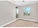 A well-lit bedroom featuring neutral walls, carpet flooring, and views of the surrounding desert landscape at 25 Via Mantova # 2, Henderson, NV 89011