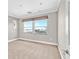 A spacious bedroom with carpet flooring and a large window with views of the surrounding landscape at 25 Via Mantova # 2, Henderson, NV 89011