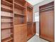 A walk-in closet with custom wood shelving and drawers, providing ample storage space at 25 Via Mantova # 2, Henderson, NV 89011