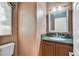 Powder room featuring granite countertop, decorative wallpaper, and vanity cabinet at 25 Via Mantova # 2, Henderson, NV 89011