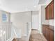 Upstairs hallway landing featuring a built in cabinet, and a window that brings in natural light at 25 Via Mantova # 2, Henderson, NV 89011