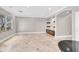 Spacious living room with tile flooring and neutral walls and built in shelves creating a welcoming atmosphere at 25 Via Mantova # 2, Henderson, NV 89011