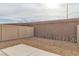 Small backyard with gravel and a beige vinyl fence at 2795 Atomic Tangerine Way # 5, Las Vegas, NV 89183