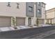 Townhouse complex exterior, featuring multiple units and garages at 2795 Atomic Tangerine Way # 5, Las Vegas, NV 89183