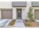 Modern townhouse exterior with attached garage and landscaping at 2795 Atomic Tangerine Way # 5, Las Vegas, NV 89183