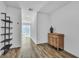 Clean hallway with wood floors, a shelf, and antique dresser at 2795 Atomic Tangerine Way # 5, Las Vegas, NV 89183