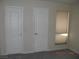 Bright bedroom with two doors and window coverings at 2838 Loveland Dr # 1619, Las Vegas, NV 89109