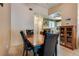 Dining room with view into kitchen, wood table and four black chairs at 2851 S Valley View Blvd # 1172, Las Vegas, NV 89102